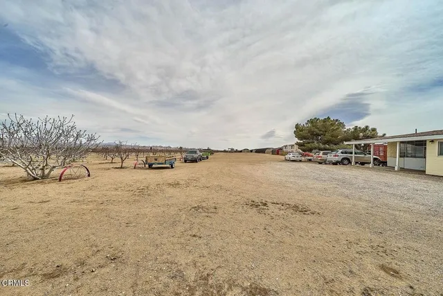 a view of a house with a parking space and a car parked in it