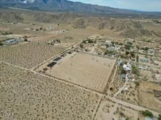 a view of a house with a wooden fence