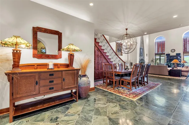 a dining room with furniture a rug and a chandelier