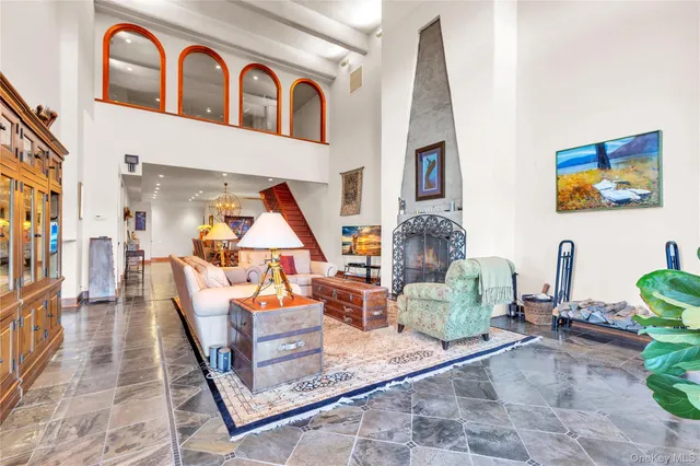 a living room with furniture fireplace and rug