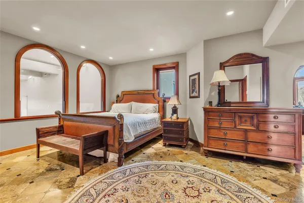 a view of a bedroom with furniture and wooden floor