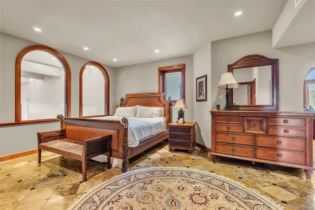 a view of a bedroom with furniture and wooden floor