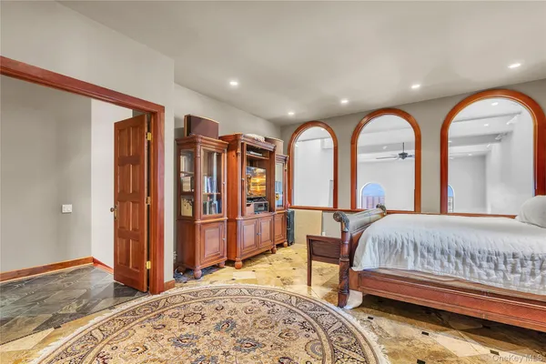 a view of a bedroom with furniture and window