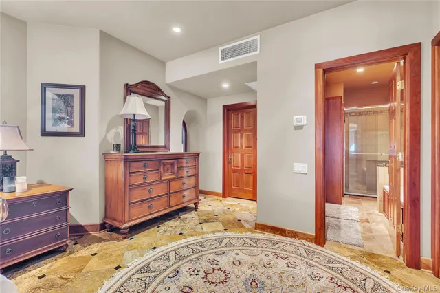 a bathroom with a granite countertop double vanity sink a mirror and a shower