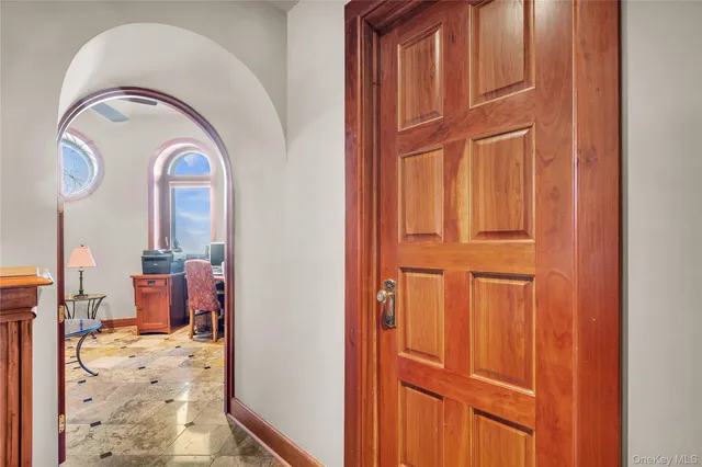 a living room with furniture a clock on wall and a clock