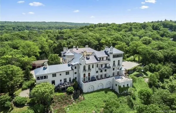 an aerial view of a house with a yard