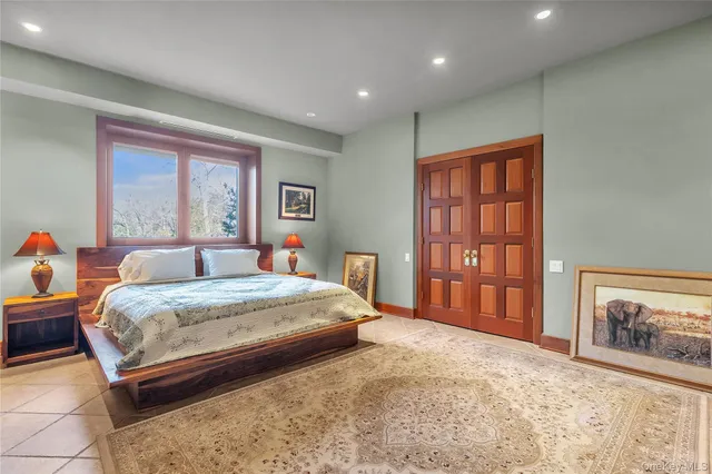 a spacious bedroom with a bed a couch and a window