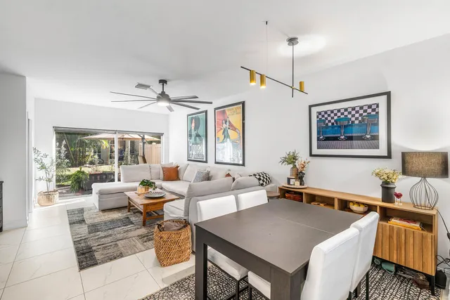 a living room with furniture two window and a table