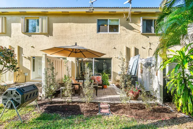 a backyard of a house with yard and outdoor seating
