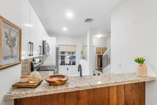 a bathroom with a granite countertop sink and a large mirror
