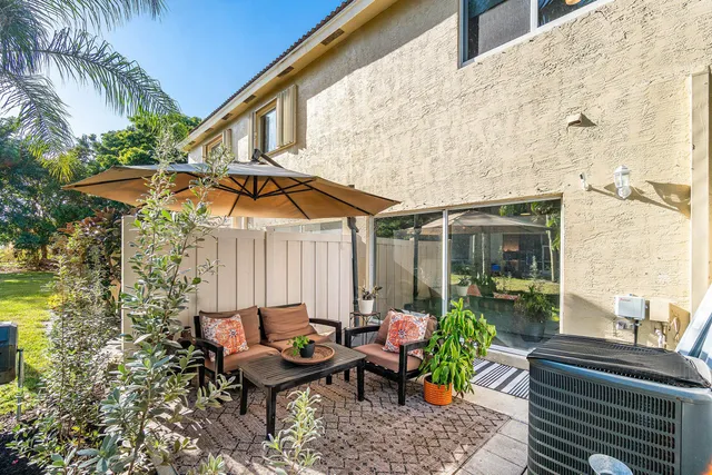 a backyard of a house with table and chairs