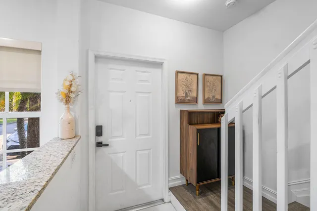 a spacious bathroom with a granite countertop sink and a mirror