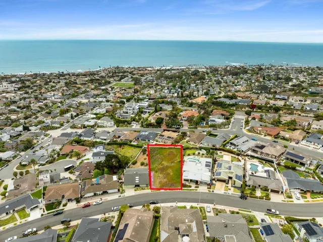 an aerial view of a residential building with an ocean