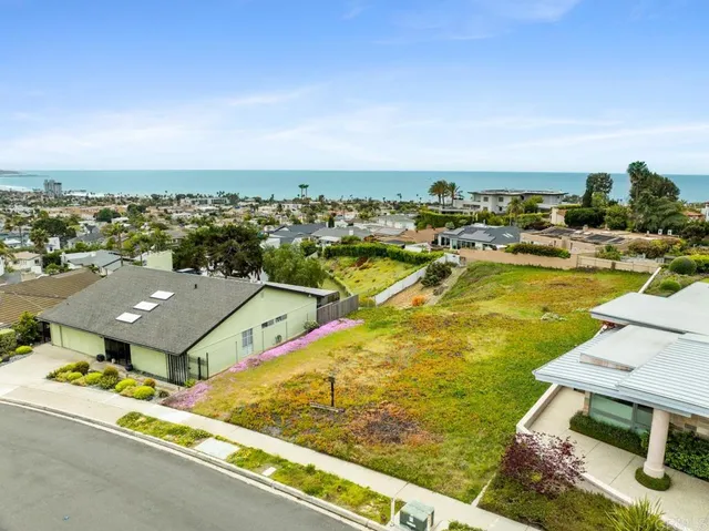 an aerial view of a house with a ocean view