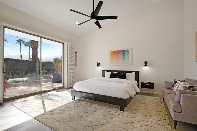 a spacious bedroom with a bed and glass door