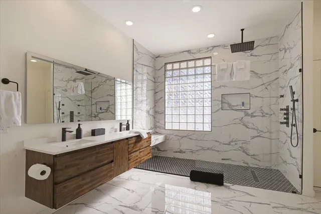 a bathroom with a bathtub sink and mirror