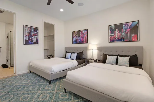 a bedroom with bed and wall painting