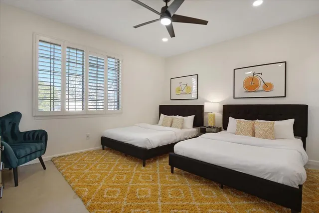 a bedroom with two beds and a window