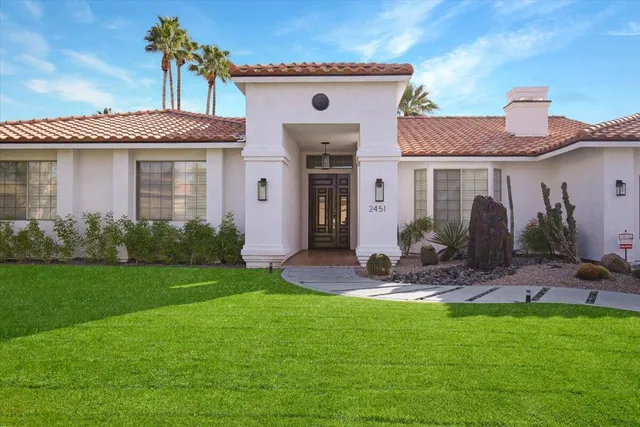 a front view of a house with garden