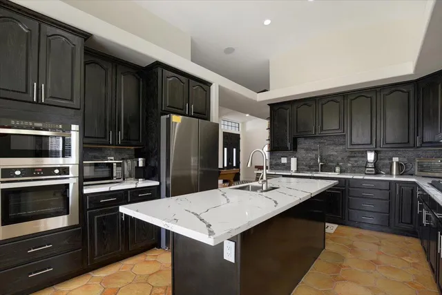 a kitchen with a sink stove and refrigerator