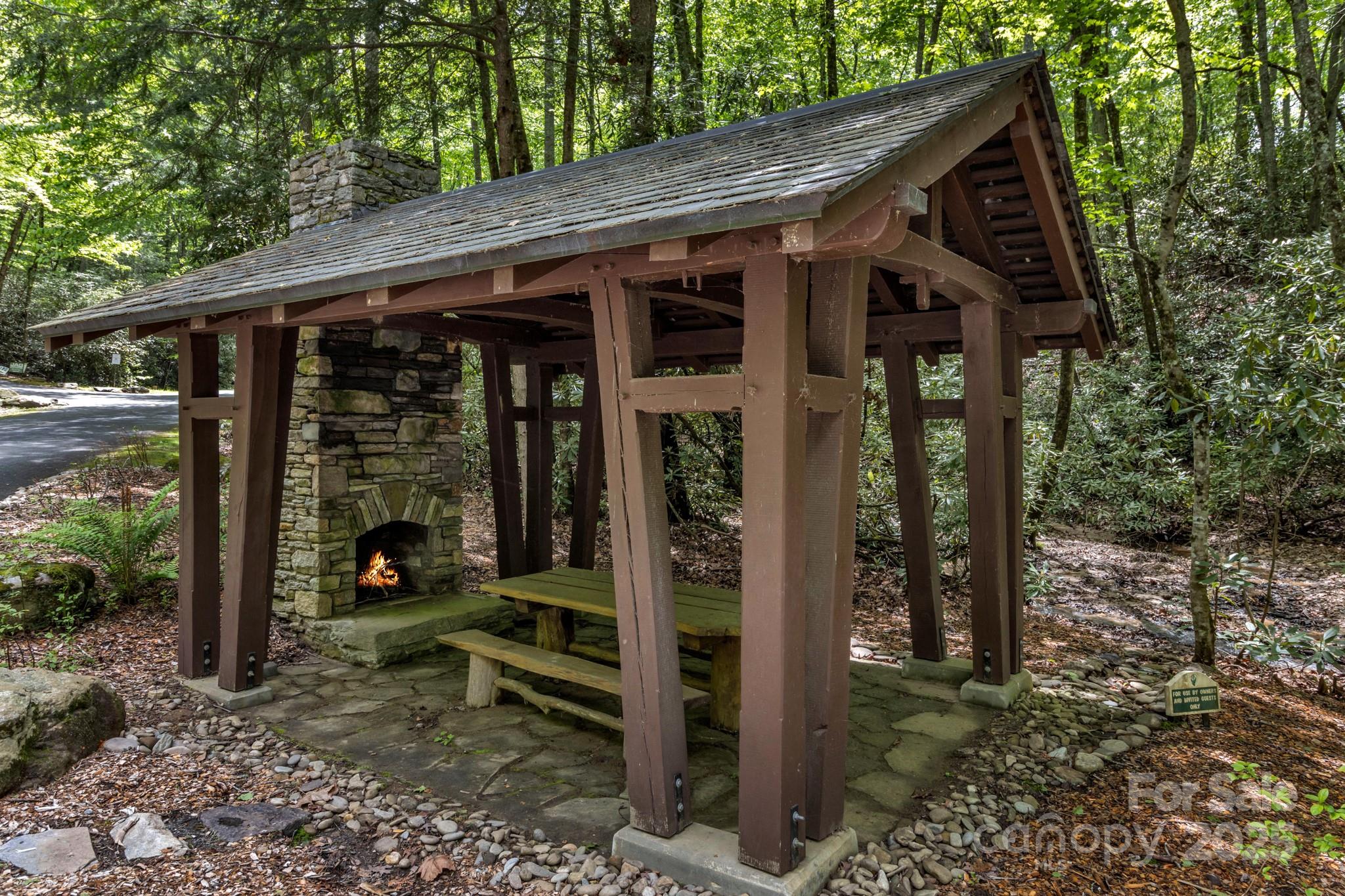 76 Drovers Lane Fairview, NC 28730 - Photo 14 of 25 a view of a patio with table and chairs under an umbrella