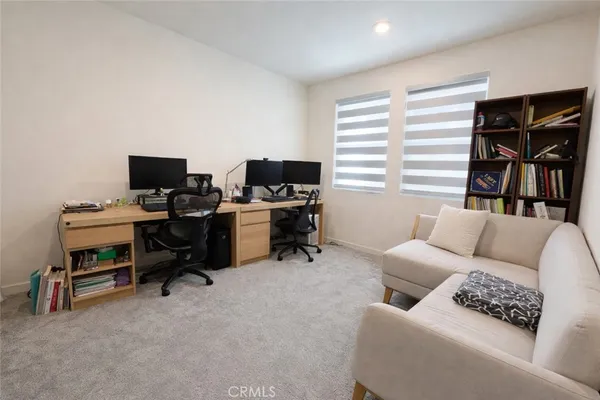 a livingroom with workspace and a couch