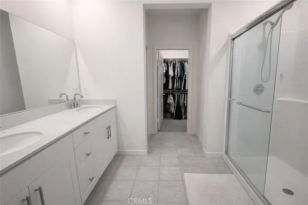a spacious bathroom with a mirror sink and shower