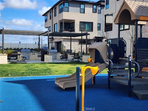 a view of a swimming pool with a bench and chairs
