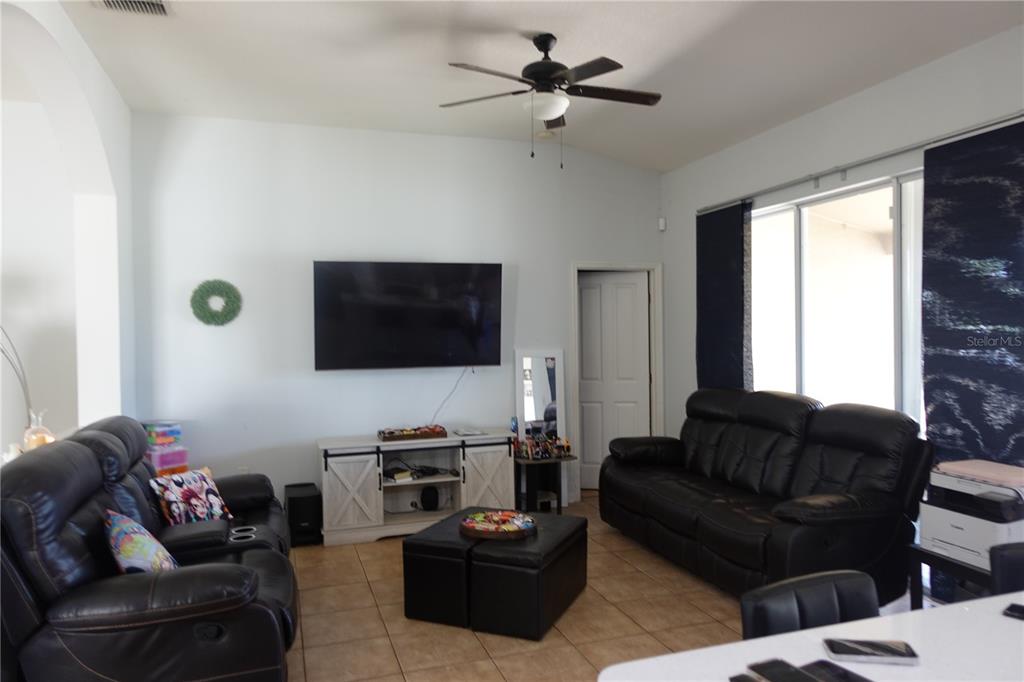 945 Tramells Trail Kissimmee, FL 34744 - Photo 15 of 36 a living room with furniture and a flat screen tv