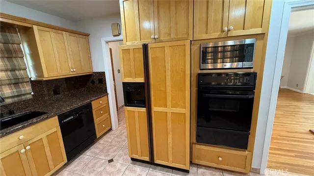 a kitchen with granite countertop cabinets and steel stainless steel appliances
