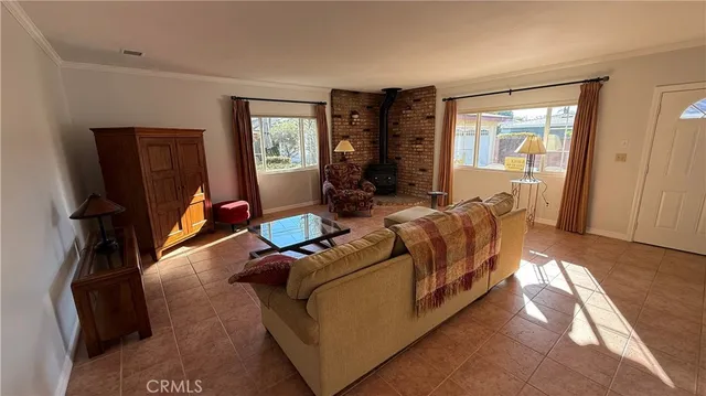 a living room with furniture a window and gym equipment