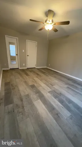 a view of an empty room with glass door