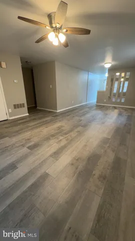 a view of a livingroom with a ceiling fan and window