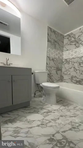 a bathroom with a sink toilet and mirror