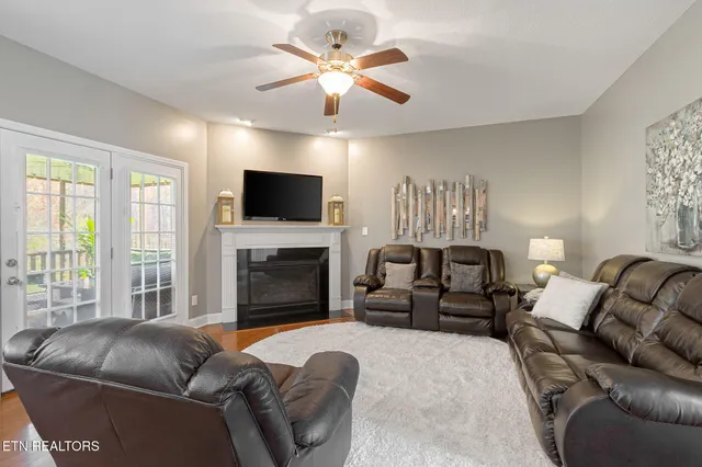 a living room with furniture a fireplace and a flat screen tv