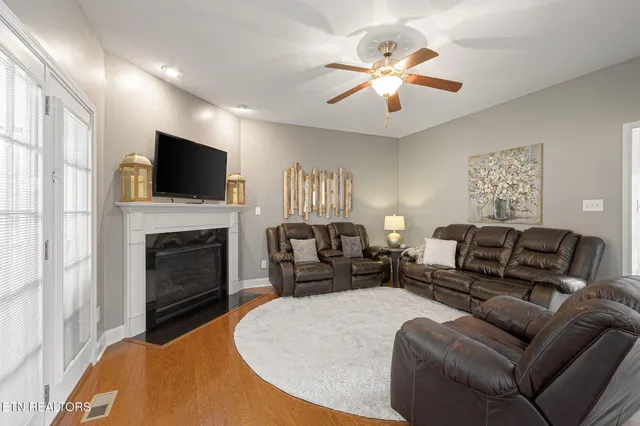 a living room with furniture a fireplace and a flat screen tv