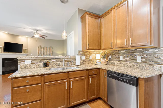 a kitchen with stainless steel appliances granite countertop a sink stove and microwave
