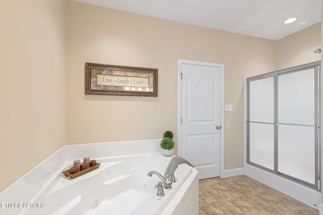 a bathroom with a tub and a shower