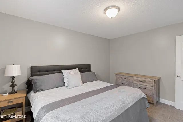 a bedroom with a bed and a night stand