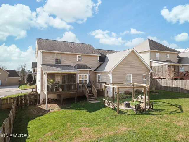 a view of a house with a yard and sitting area