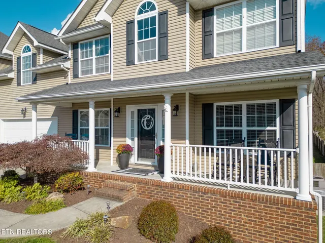 front view of a brick house with a large window