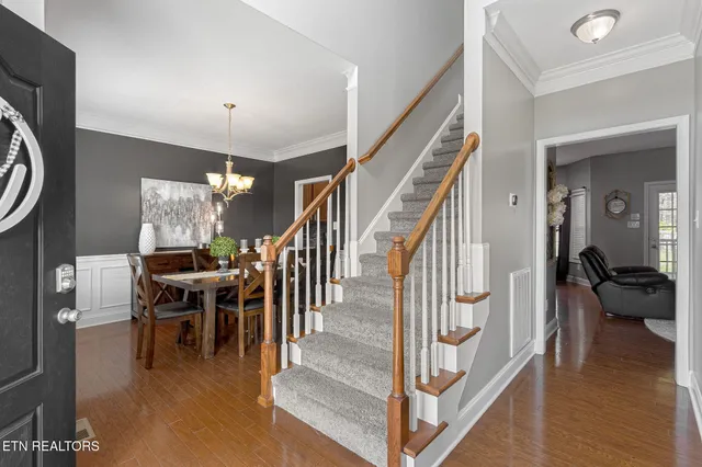 a dining room with furniture entryway and wooden floor