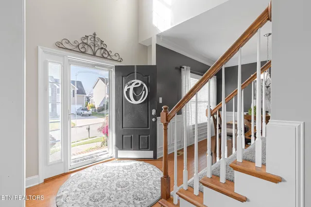 a view of entryway and hall with wooden floor