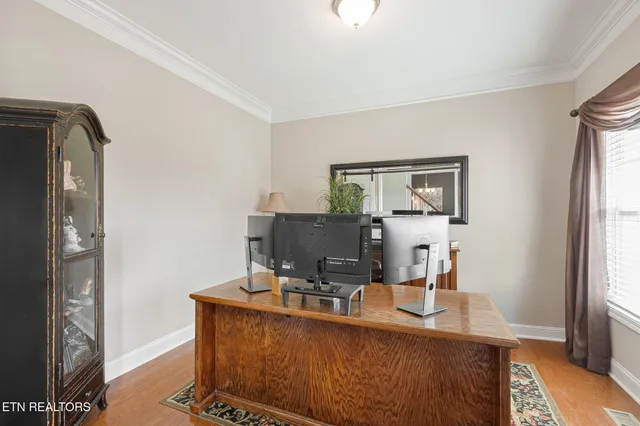 a view of a workspace with furniture and a window