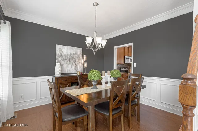 a view of a dining room with furniture and chandelier