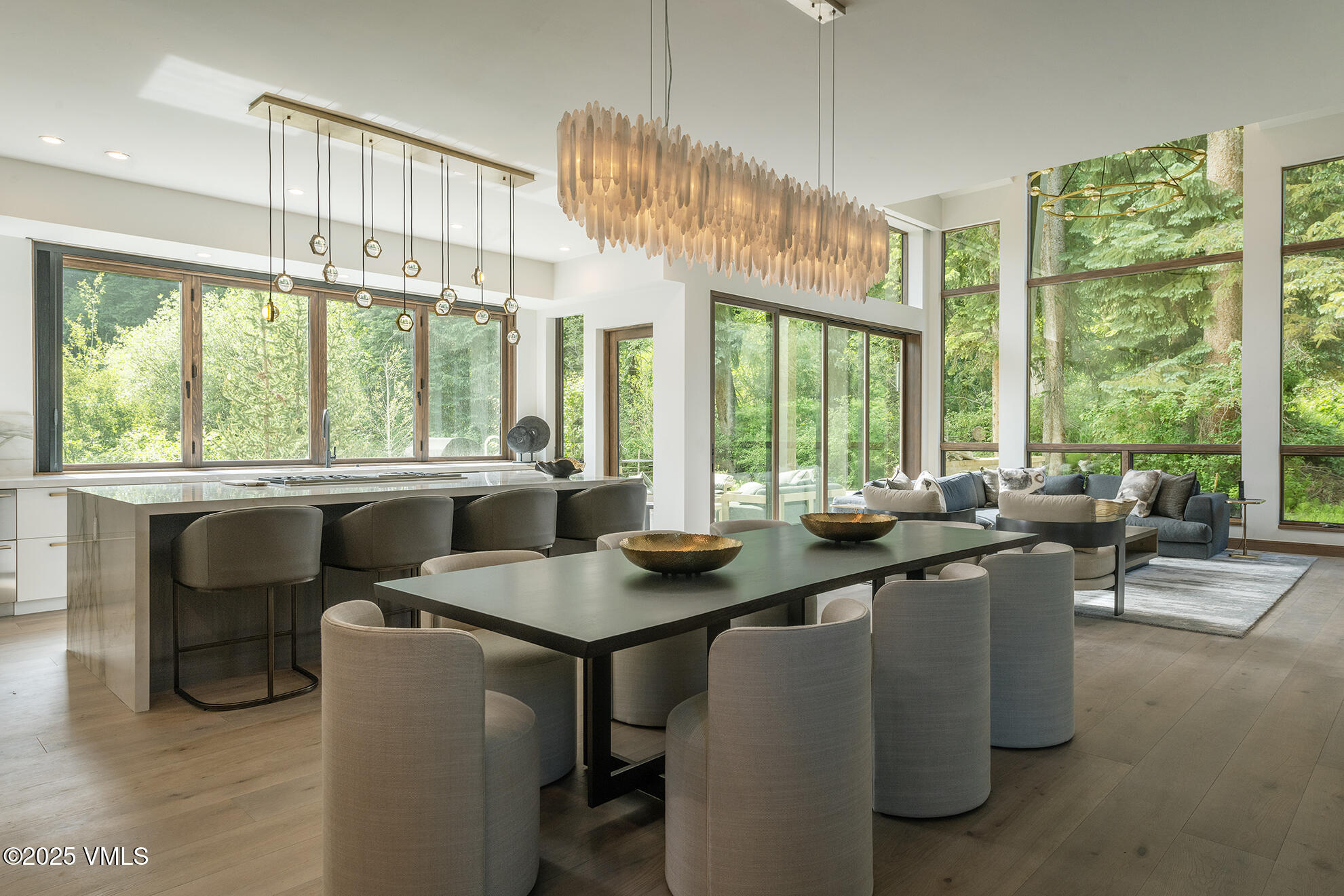 187 Elk Track Road Beaver Creek, CO 81620 - Photo 9 of 19 a dining room with furniture a large window and a chandelier