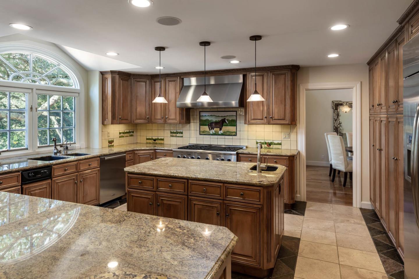 340 Jane Drive Woodside, CA 94062 - Photo 18 of 48 a kitchen with a stove window and cabinets