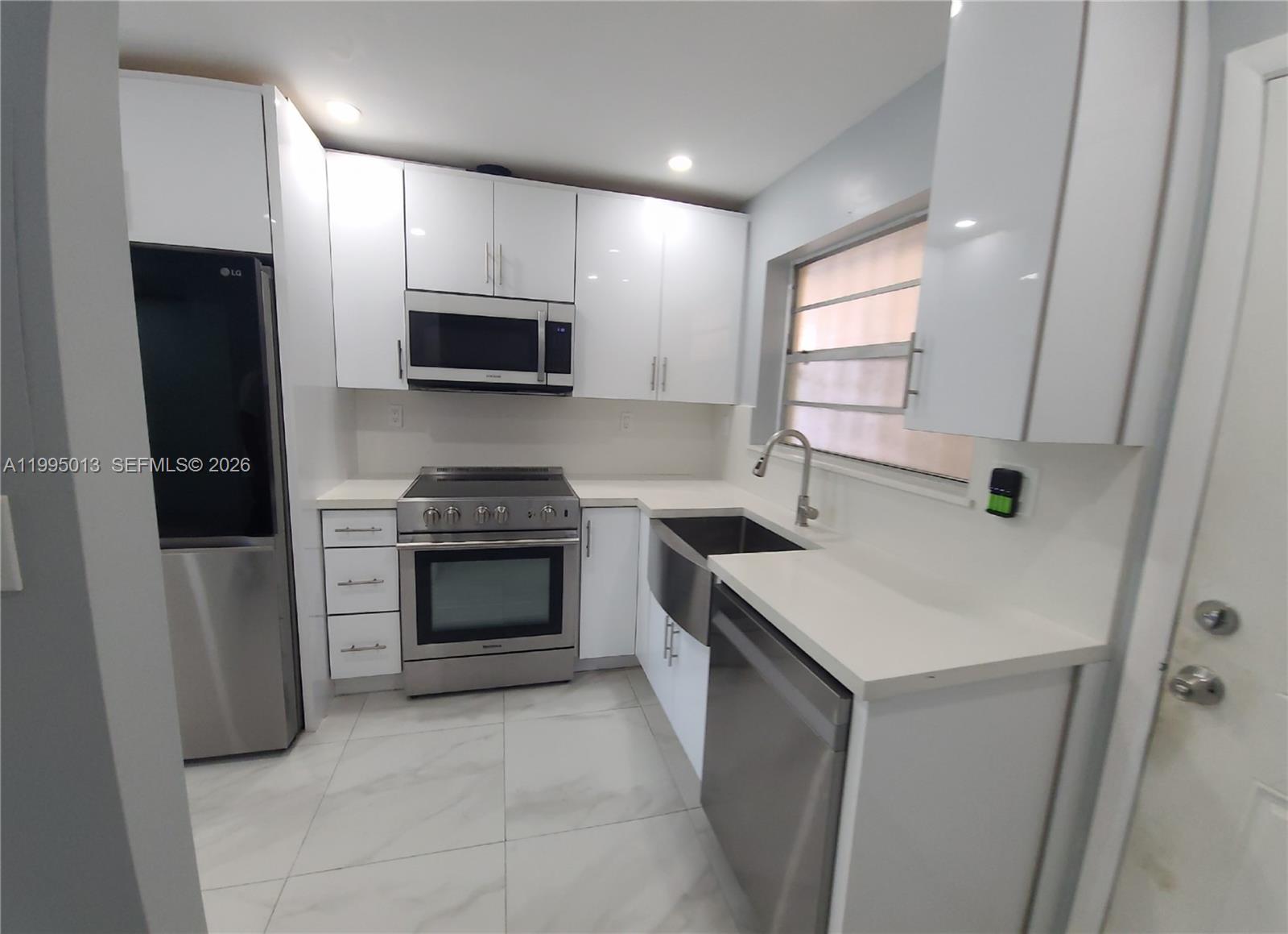 453 Southwest 2nd Street, Unit 306C Miami, FL 33130 - Photo 2 of 18 a kitchen with a stove and a microwave