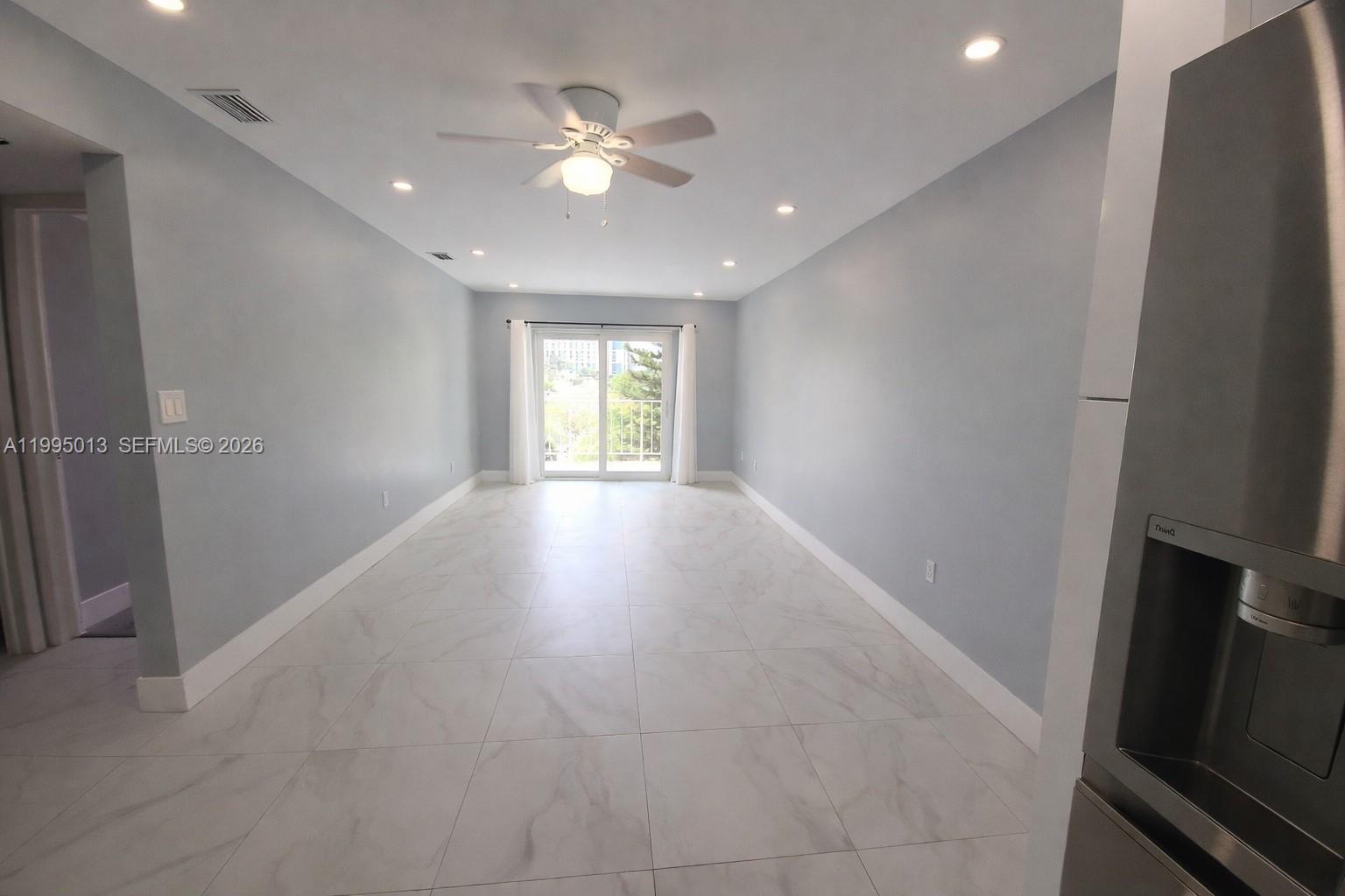 453 Southwest 2nd Street, Unit 306C Miami, FL 33130 - Photo 4 of 18 wooden floor in an empty room with a window