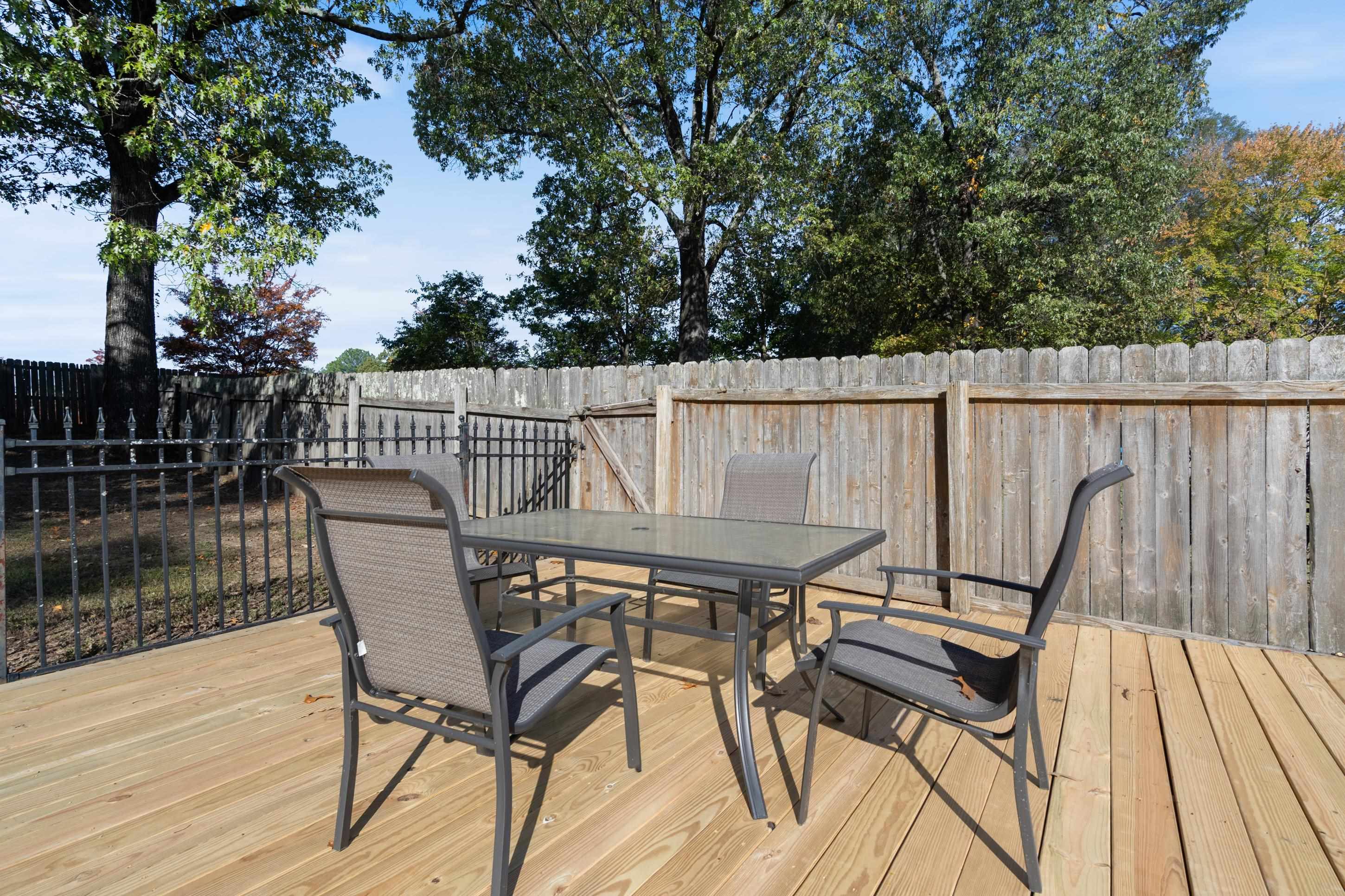 301 Dove Valley Road Collierville, TN 38017 - Photo 24 of 32 a view of a patio with table and chairs with wooden floor and fence